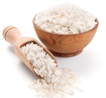 long grain rice in a wooden bowl isolated on white
